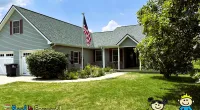 a house with a flag in the front yard