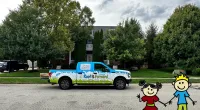 a car parked in front of a building with a cartoon character in front