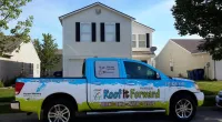 a Roof It Forward truck parked in front of a house