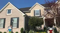 a large brick building with a sign in front of a house