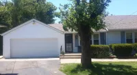 a tree in front of a customer's home