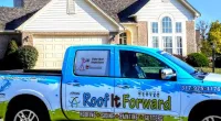 a Roof It Forward truck parked in front of a house