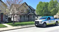 a Roof It Forward truck parked in front of a house