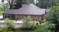 a home with Brandy Wine colored synthetic slate roofing