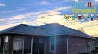 Sunset over a brick house roof with the Roof It Forward logo featuring colorful children drawings in the sky.