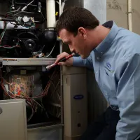 HVAC Technician working on Carrier gas furnace in Pittsburgh, PA