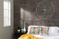Thumbnail for Cozy bedroom with patterned pillows, yellow throw blanket, decorative wall art, and natural light from window