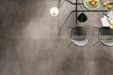 Thumbnail for Top view of modern glass dining table with chairs, pendant lights, a bowl of lemons, and scattered papers.