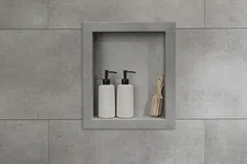 Thumbnail for Built-in gray tiled shower niche holding two white pump bottles and a small wooden brush.
