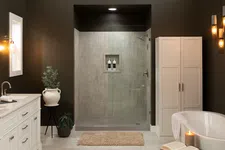 Thumbnail for Modern bathroom with white vanity, freestanding tub, glass shower, dark walls, and soft lighting