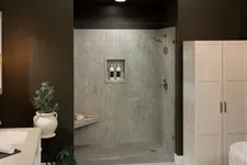 Thumbnail for Modern bathroom with double sink, glass shower enclosure, dark walls, and white storage cabinet with plants.