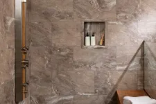 Thumbnail for Modern shower area with large stone tiles, rain showerhead, built-in shelf with toiletries, and wooden bench with towels.