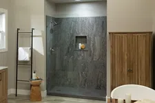 Thumbnail for Modern bathroom with wooden vanity, glass shower, freestanding tub, and neutral color scheme