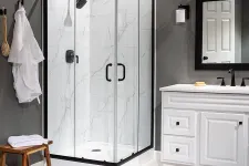 Thumbnail for Modern bathroom with glass shower enclosure, white vanity, round mirror, and wooden bench with towels.