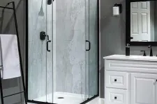 Thumbnail for Modern corner glass shower with black frame, gray tile walls, white vanity, and towel rack in sleek bathroom