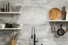 Thumbnail for Modern kitchen sink with black faucet, marble tile backsplash, floating shelves holding kitchenware and utensils.