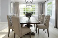 Thumbnail for Modern dining room with tufted beige chairs, dark wood table, large windows, and decorative ceiling light fixture