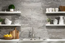 Thumbnail for Modern kitchen sink with stainless faucet, white shelves, gray stone backsplash, and decorative kitchenware.