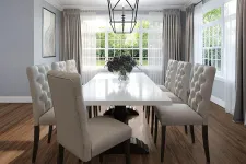 Thumbnail for Bright dining room with white table, tufted beige chairs, wood floor, large windows, and decorative ceiling light fixture