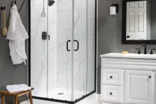 Thumbnail for Modern bathroom with glass shower enclosure, white marble tiles, black fixtures, and white vanity with mirror.