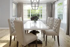 Thumbnail for Bright dining room with large windows, beige tufted chairs, a white table, wooden floor, and decorative pendant light.