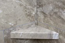 Thumbnail for Corner marble shower shelf with beige and brown natural stone texture and polished finish.