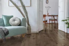 Thumbnail for Modern living room with light teal sofa, round cushions, wooden floor, decorative dried plants, and dining area in background