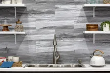 Thumbnail for Modern kitchen with stainless steel sink, stylish faucet, gray marble backsplash, and open white shelves.