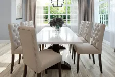 Thumbnail for Modern dining room with beige tufted chairs, white marble table, large windows, and natural wood flooring.