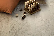 Thumbnail for Wooden strategy game with light and dark pieces near two rust-colored cushions on a textured floor.