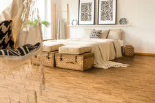 Thumbnail for Cozy bedroom with beige bed, woven baskets, patterned cushions, animal print wall art, and hanging macrame chair.