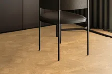 Thumbnail for Modern black chair with textured leather and metal legs in a minimalist room with tan cork flooring.
