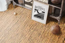 Thumbnail for Rustic storage unit with fabric bins, vintage leather balls, and a framed baseball championship poster on textured floor.