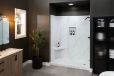 Thumbnail for Modern bathroom with glass shower, marble tiles, wooden vanity, black cabinet, and indoor plant.