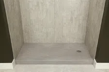 Thumbnail for Empty walk-in shower with beige stone tile walls and gray floor with central drain on raised platform.