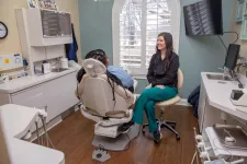 Thumbnail for Dentist consulting with patient in a modern dental office with natural light from arched window.
