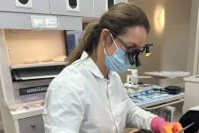 Thumbnail for Female dentist wearing magnifying glasses and mask working on a dental patient in a modern clinic.