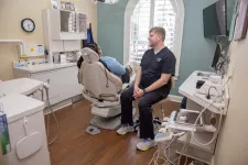 Thumbnail for Dentist consulting a patient in a modern dental office with a dental chair and equipment.