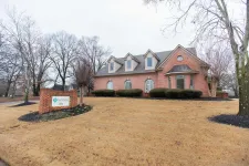 Thumbnail for Brick office building with manicured shrubbery and a sign for Volner Insurance on a overcast day