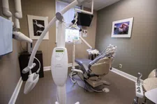 Thumbnail for Modern dental office with Philips Zoom teeth whitening machine and dental chair covered in plastic.