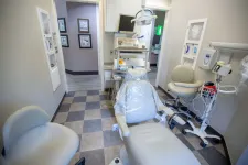 Thumbnail for Clean dental exam room with patient chair, medical equipment, and bright lighting on checkered floor.