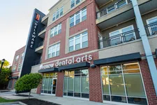 Thumbnail for Modern brick dental clinic building named Renew Dental Arts with large windows and outdoor sign in daylight