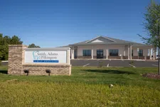 Thumbnail for Front view of Smith Adams Pilkington Family Dentistry building and sign under clear blue sky.