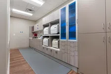 Thumbnail for Modern dental sterilization room with autoclaves, cabinets, and wood flooring under fluorescent lighting