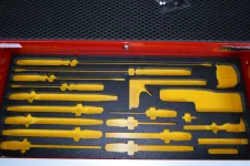 Thumbnail for Yellow tool silhouettes arranged in black foam inside a red toolbox drawer with a textured black background.