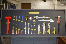Thumbnail for Organized wall-mounted tool board labeled Abrasive with hammers, screwdrivers, wrenches, pliers, and measuring tape