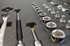 Thumbnail for Close-up of a socket wrench set organized in a black foam case with various sizes of sockets and tools.