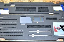 Thumbnail for Organized foam case containing drill bits, clamps, and precision tools on wooden surface.