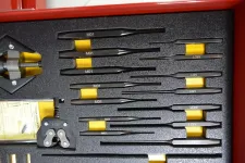 Thumbnail for Set of precision screwdrivers and tools neatly arranged in a red toolbox foam insert