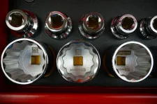 Thumbnail for Set of shiny chrome socket wrenches with square drive holes organized in a red toolbox.